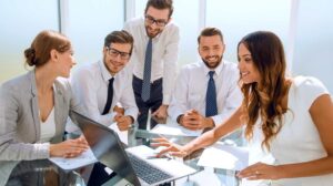 business team uses laptop check marketing communications ss Feature